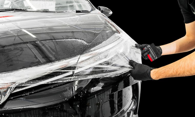 Car paint protection film is being applied to the hood in Portland, OR